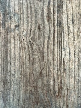 Detailed surface texture of vertical weathered dark wood grain plank showing natural lines and age.