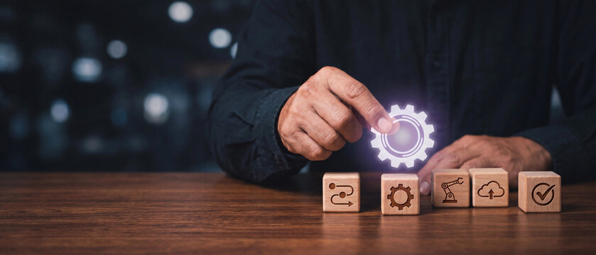Business process automation and digital transformation concept with a person placing a gear icon on wooden blocks