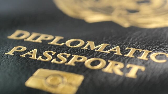 Close-up cinematic shot of diplomatic passport, featuring golden embossed text and official emblem, dynamic motion footage