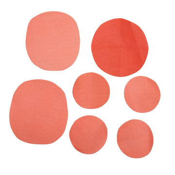 Group of seven salmon pink paper circles of varying sizes isolated on a transparent background