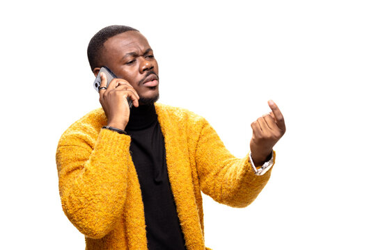 Man expressing disagreement while on a phone call wearing a cozy sweater and showcasing assertive body language
