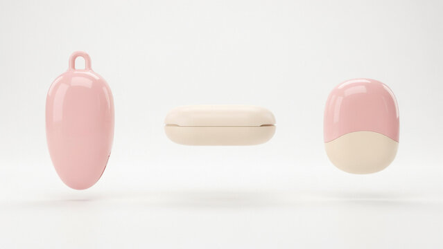 Three smooth pastel pink and cream colored pill shaped on a plain white background