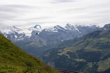 Paraglider Soaring Above an Alpine Valley © Brian