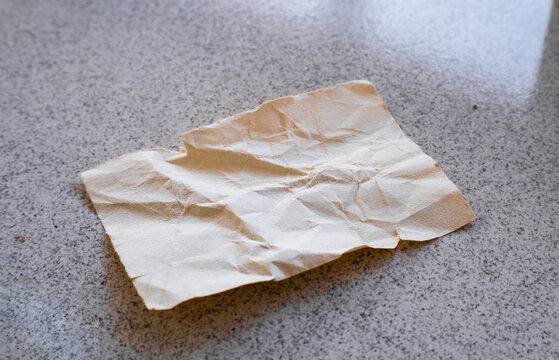 a crumpled piece of paper on the floor