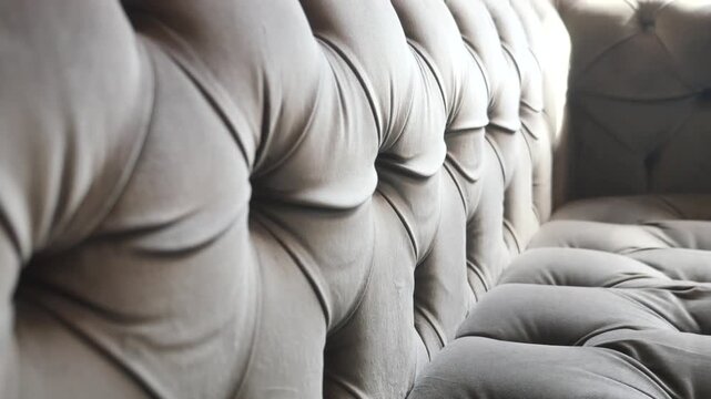 Close up slow motion of classic tufted upholstery with button details, luxurious textile texture moving gently