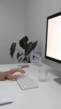 Hands Typing on Computer While Working Remotely at Modern Home Office