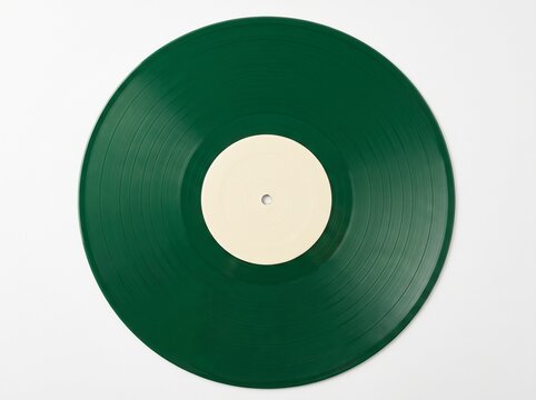 Top view of a dark green vinyl record with a blank cream center label isolated on a white background, minimalist music object