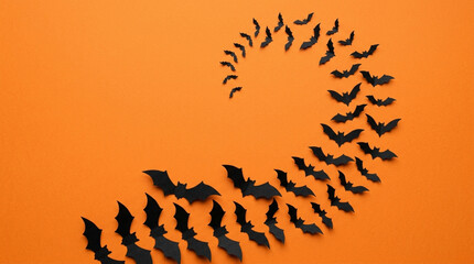 Obraz premium Halloween bats spiral on orange background, spooky festive decoration