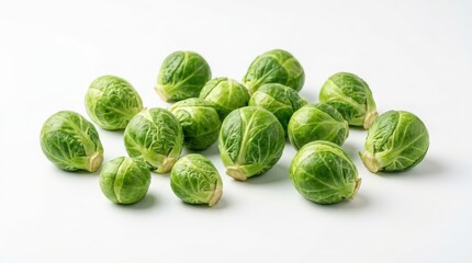 Fototapeta premium Group of fresh raw brussels sprouts arranged on a white background with green vegetables vegetable pile cruciferous vegetables organic vegetables mini cabbage dietary food vegan diet plant food