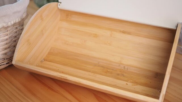 Freshly baked bread displayed in a wooden box on a kitchen counter