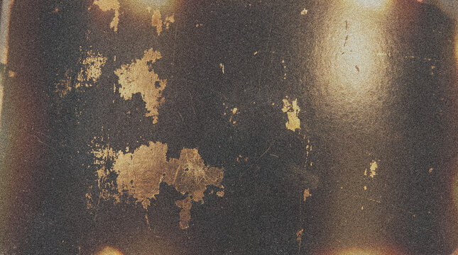 Dark distressed surface with golden grunge texture and light flares