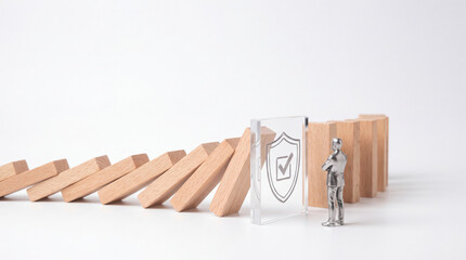 Fototapeta premium Business Risk Management and Insurance Concept with Businessman Figure Watching a Protective Glass Shield Stop Falling Wooden Domino Blocks from Collapsing on White Background