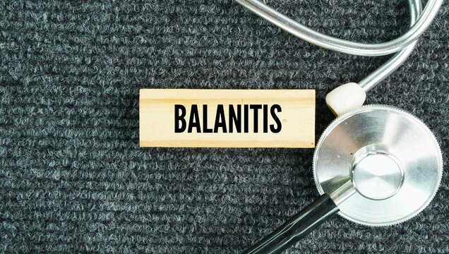 Stethoscope and stick with the word Balanitis is the swelling, pain, and inflammation of the head glans of the penis. medical concept