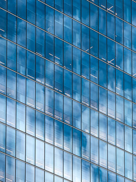 Blue sky and clouds reflected in skyscraper windows