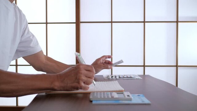 Senior Man Raising Index Finger During Medication Management at Home