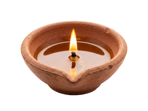 A traditional clay oil lamp with a burning flame, isolated on transparent background