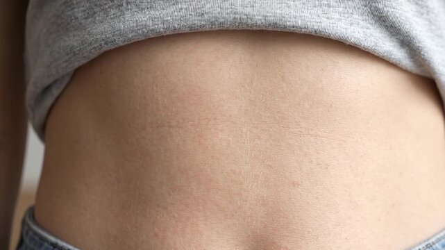 Close Up of Woman Smooth Flat Abdomen and Navel in Denim Jeans