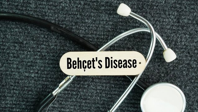 Stethoscope and stick with words Beh&ccedil;et's disease is a rare, chronic inflammatory disorder that causes blood vessel inflammation vasculitis throughout the body, leading to recurrent sores, eye inflamm