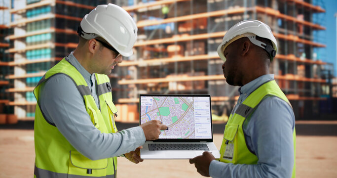 Civil Engineer And Contractor Review Site Plans Discussing Project Development