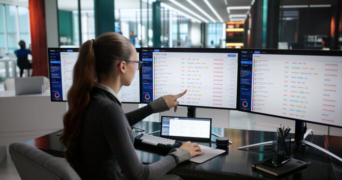 Woman At Computer Solving Technical Issues Through Service Ticket System