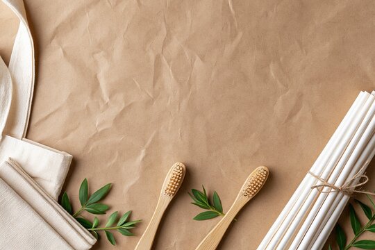 eco friendly bamboo toothbrushes and straws on brown
