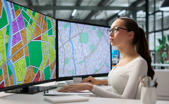 Young Woman Reviews City Zoning Data On Computer