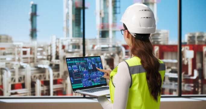 Young Female Engineer Uses Laptop To Monitor Safety