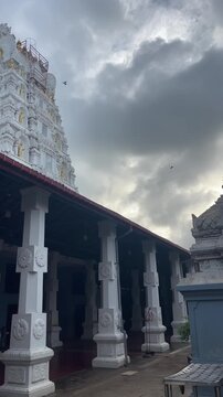 Atmospheric view of Munneswaram Hindu Temple architecture and gopuram beneath dramatic clouds in Chilaw, Sri Lanka.