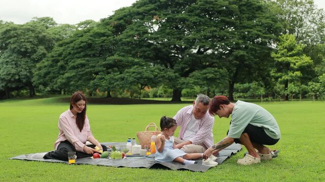 Father, Little girl walking and spending time with father in the park. Happy Asian family having fun time on picnic at city nature park, outdoor activitie