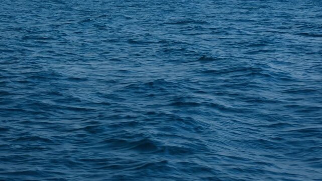 Top view of deep blue sea water surface with small ripples, aerial drone shot of turquoise ocean texture at island , abstract nature background	