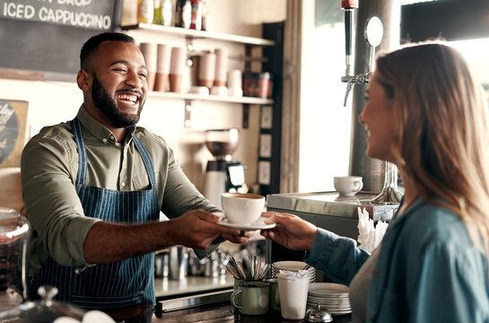 Giving, counter and man with customer in coffee shop for friendly service, order and hospitality. Happy, restaurant and barista with collection for drink, beverage and espresso for woman in cafeteria