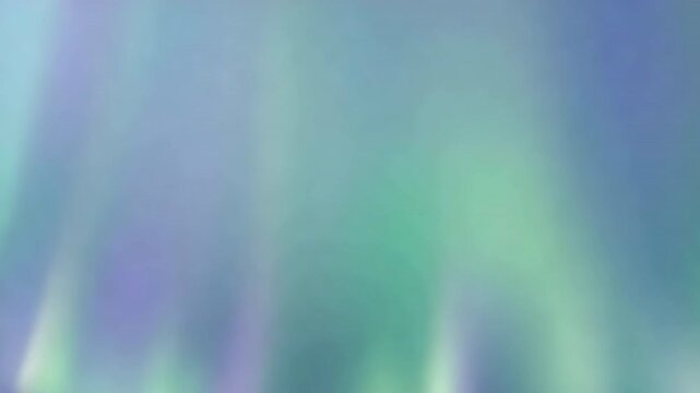 Abstract ethereal light waves shifting with soft glowing green and blue colors.