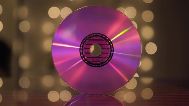 Readable surface of compact disc is iridescent because against abstract background close-up