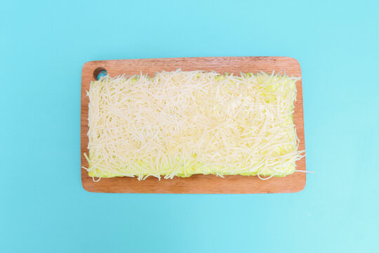 Delicious avocado flavored cake topped and filled with creamy frosting, generously covered with fine shredded cheese