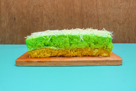 Delicious avocado flavored cake topped and filled with creamy frosting, generously covered with fine shredded cheese