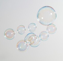 Fototapeta premium Colorful soap bubbles floating against white background