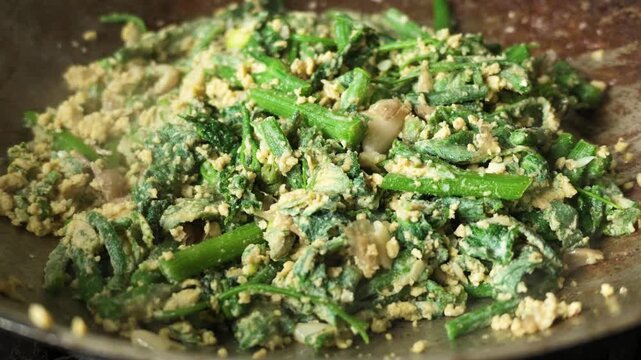 Slow Motion of Stir-Frying Chayote Shoots with Egg in Wok