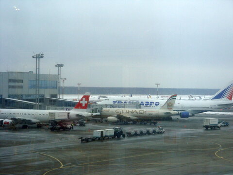 Moscow, Russia. January 3, 2012: Airplanes of Swiss, Etihad Airways, and Transaero parked at the gates of Domodedovo International Airport on a winter day.