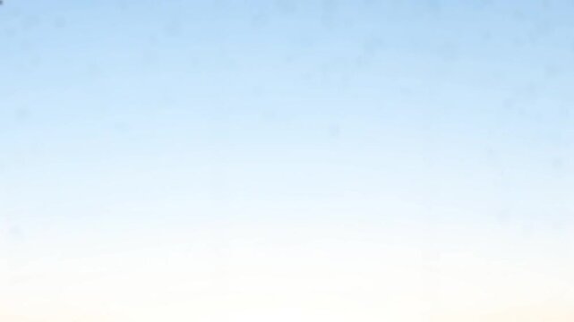 Clear blue sky with subtle cloud particles drifting slowly across the frame