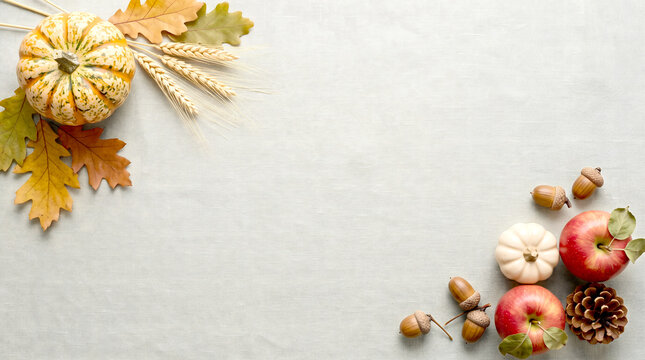 Autumn harvest background with pumpkins apples and leaves on wood