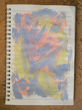 Colorful Abstract Paint Strokes on Spiral Notebook Page, Art Supply Flat Lay