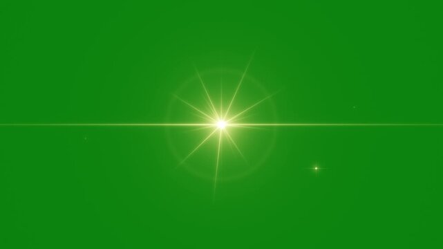 Golden starburst lens flare on green screen, glowing gold star glint with horizontal streak and twinkling sparkles