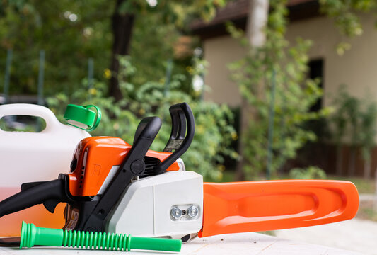Chainsaw with Fuel Container Outdoors