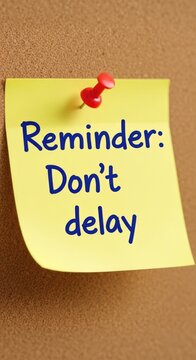 Yellow sticky note with the message Reminder Dont delay pinned to a brown textured surface.