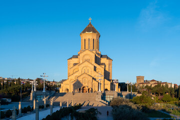 Obraz premium The Holy Trinity Cathedral of Tbilisi bathed in golden hour sunlight
