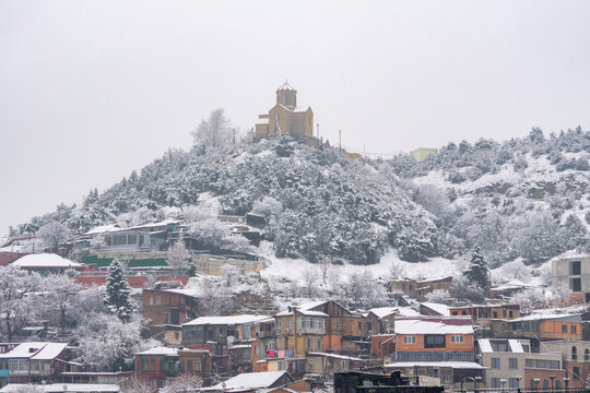 Snow covered Tbilisi old town with Tabor Monastery of the Transfiguration on a hill