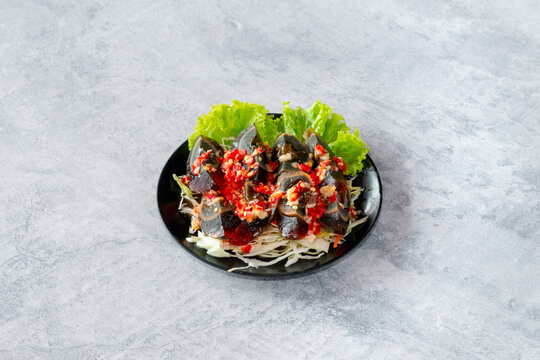 Diced century eggs tossed in a vibrant Thai salad dressing with fresh chilies, lime juice, shallots, and cilantro.