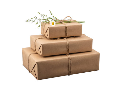 Stack of three gift boxes wrapped in brown kraft paper tied with twine string isolated on white background