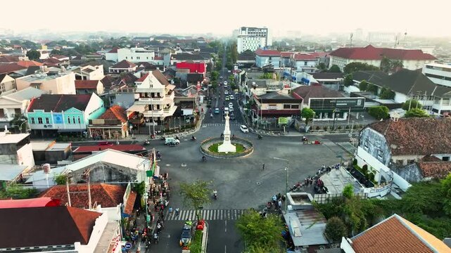 Aerial panorama of Tugu Jogja landmark and central Yogyakarta city traffic
