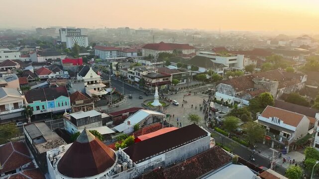 Golden hour aerial panorama of Tugu Jogja and Yogyakarta urban skyline